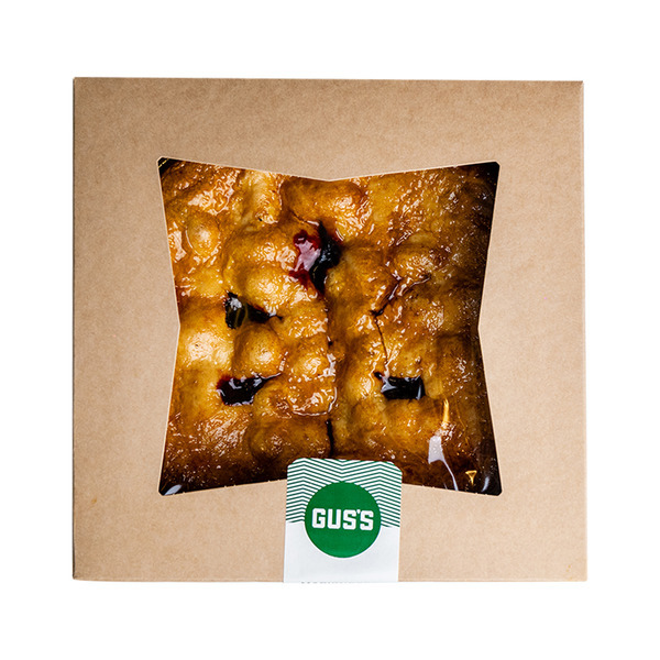 A Gus's pie in a brown box with a clear window and a green Gus's label.