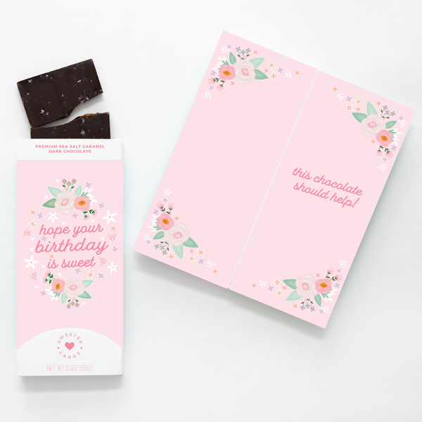 A pink chocolate bar package with floral designs and the text 'hope your birthday is sweet'.